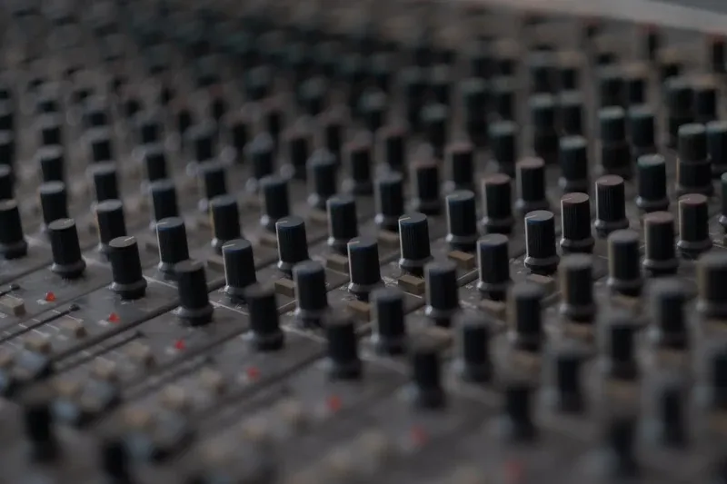 The faders of a mixing desk